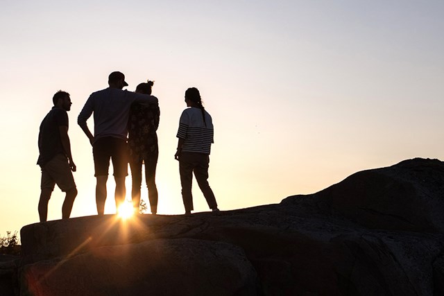 People on a hill during sunset