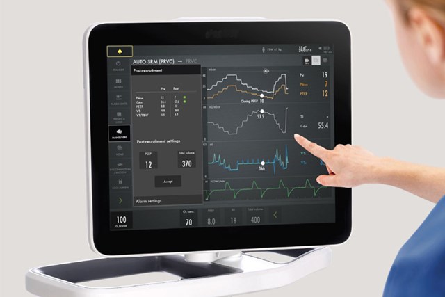 Clinicians hand touching screen of a Getinge Servo-u mechanical ventilator in Automatic Stepwise Recruitment Maneuver mode 